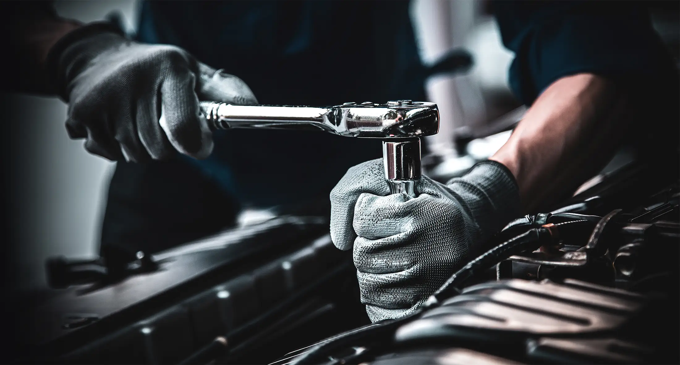 Nahaufnahme eines Kfz-Technikers/Mechanikers, der mit dem Schraubenschlüssel Reparaturen durchführt